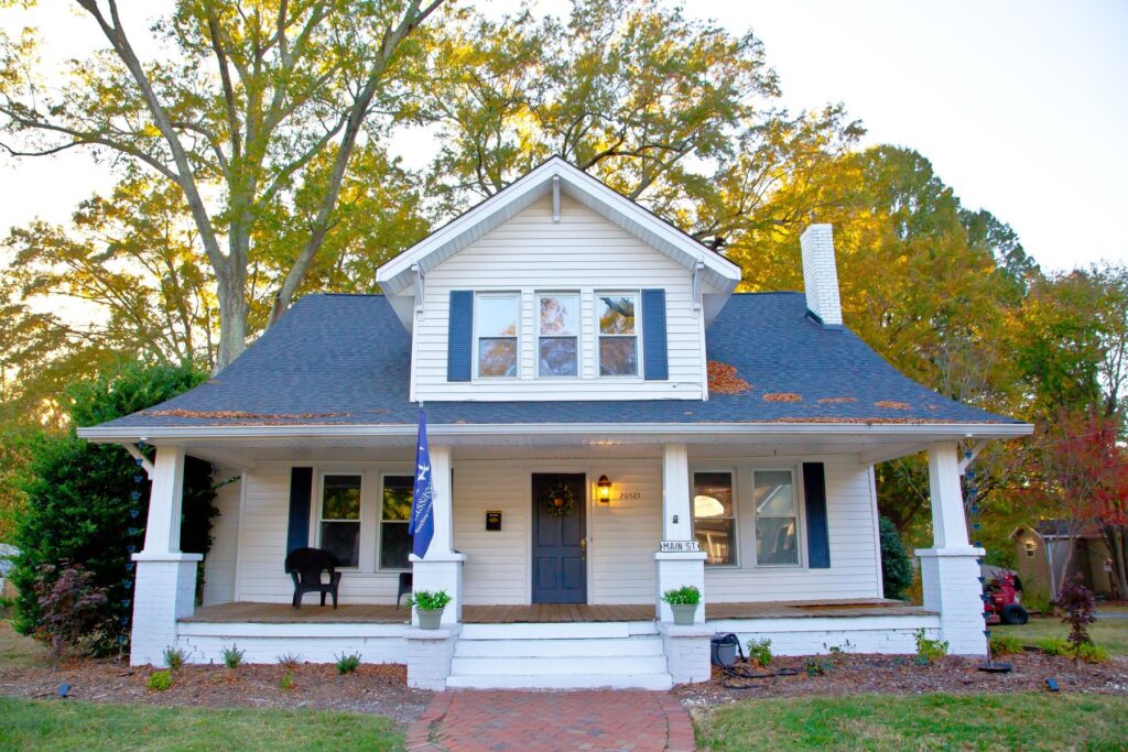 NC Massage School, a white two-story house with a covered front porch on North Main Street in Cornelius, North Carolina